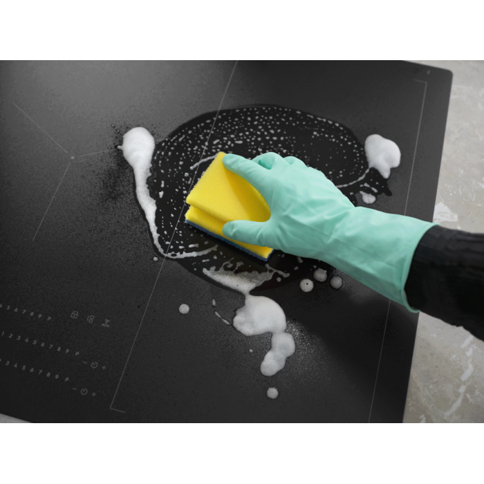 Hob Cleaner being applied with foam and sponge, highlighting its easy-to-clean feature.